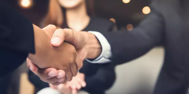 Businessmen making handshake with his partner in cafe - business etiquette, congratulation, merger and acquisition concepts