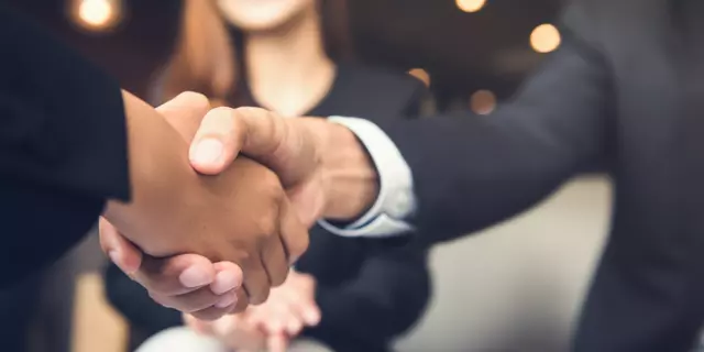Businessmen making handshake with his partner in cafe - business etiquette, congratulation, merger and acquisition concepts
