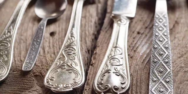 old cutlery on wooden table