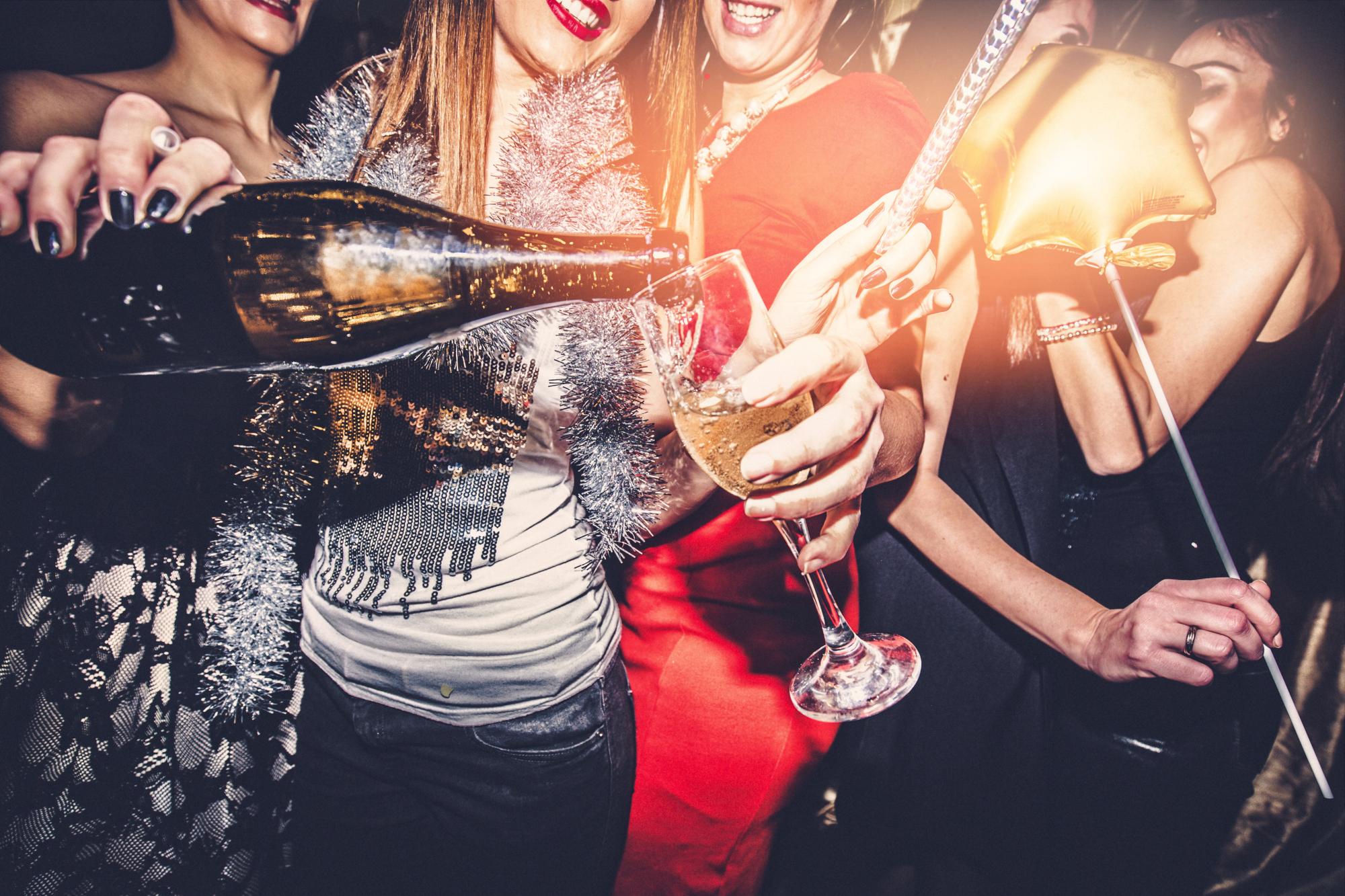 Smiling group of women drinking champagne and celebrating