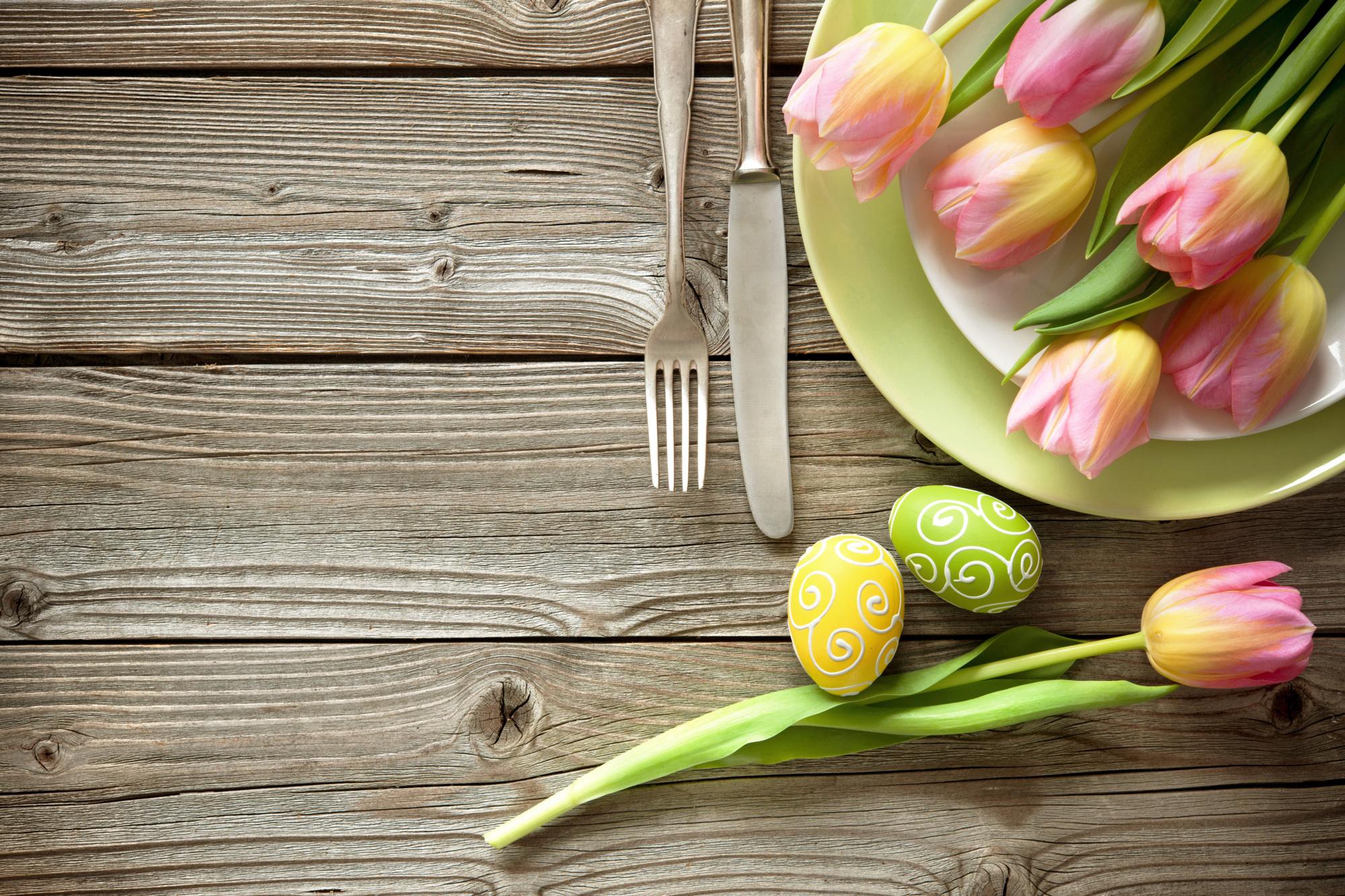 Easter table setting with spring tulips and cutlery. Holidays background