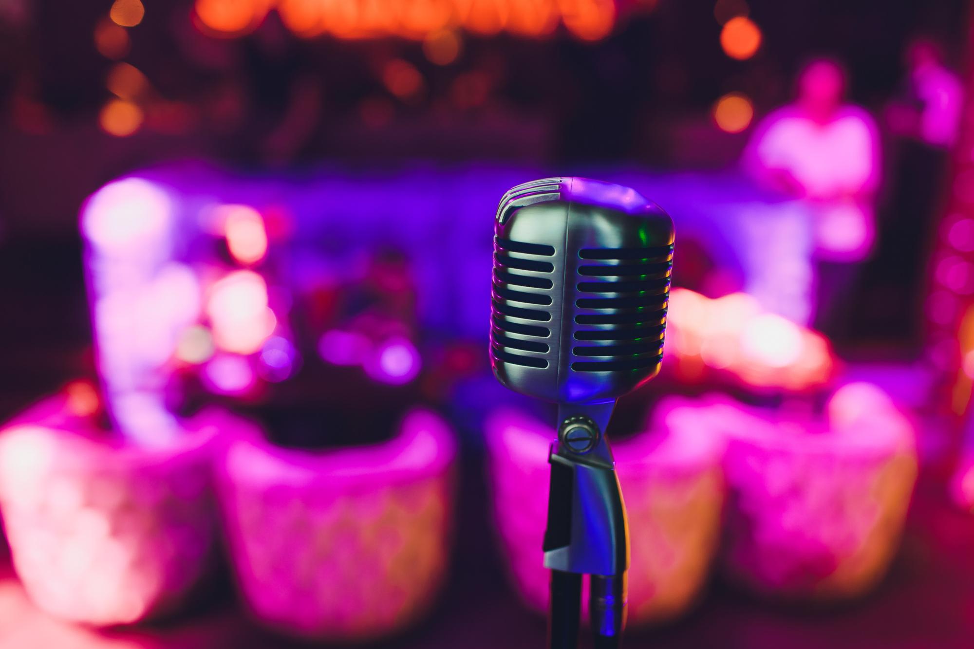 Retro microphone against blur colorful light restaurant background