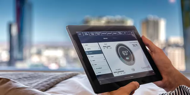 ARIA hotel bedroom with a tablet to control room settings.