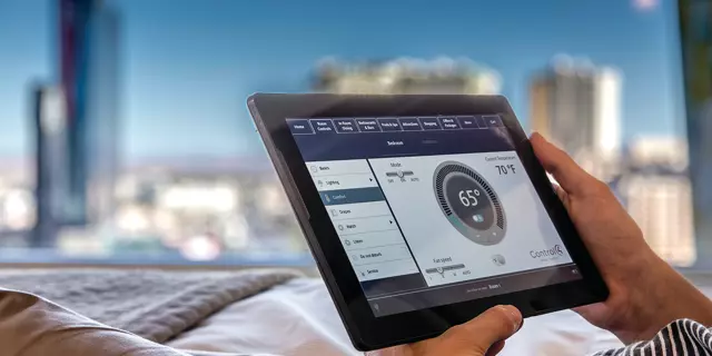 ARIA hotel bedroom with a tablet to control room settings.