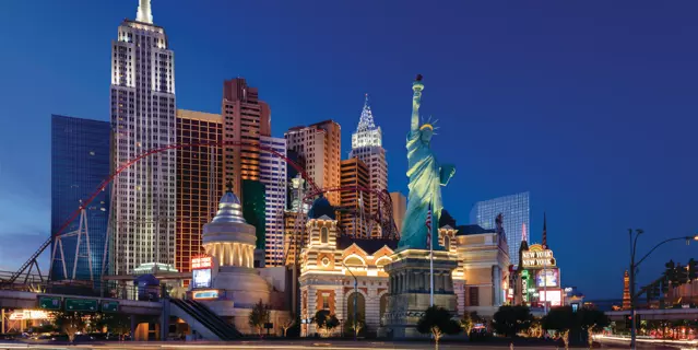 Exterior of New York-New York shows various skyscrapers mimicking iconic New York City buildings with a replica of the Statue of Liberty in front.