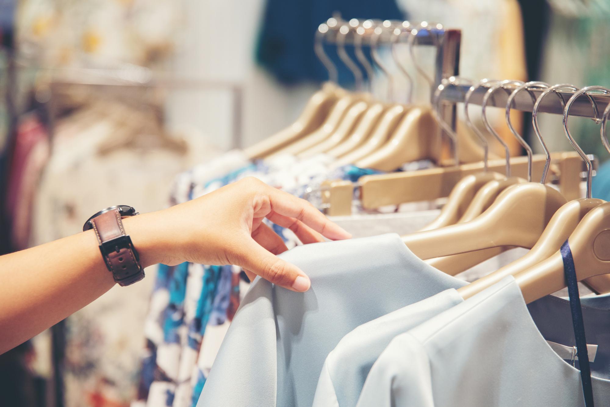 hand of customer choosing clothes in a clothing store