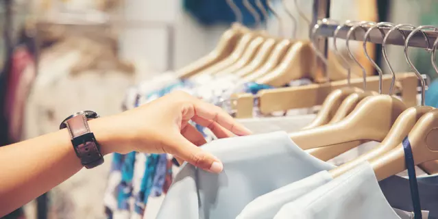 hand of customer choosing clothes in a clothing store