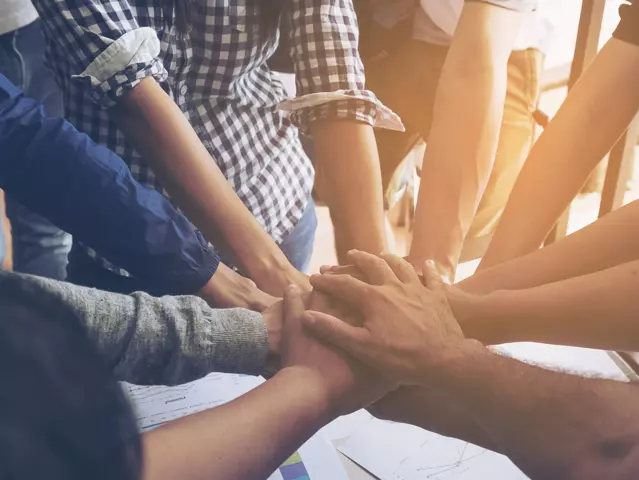 Business people join hand together during their meeting