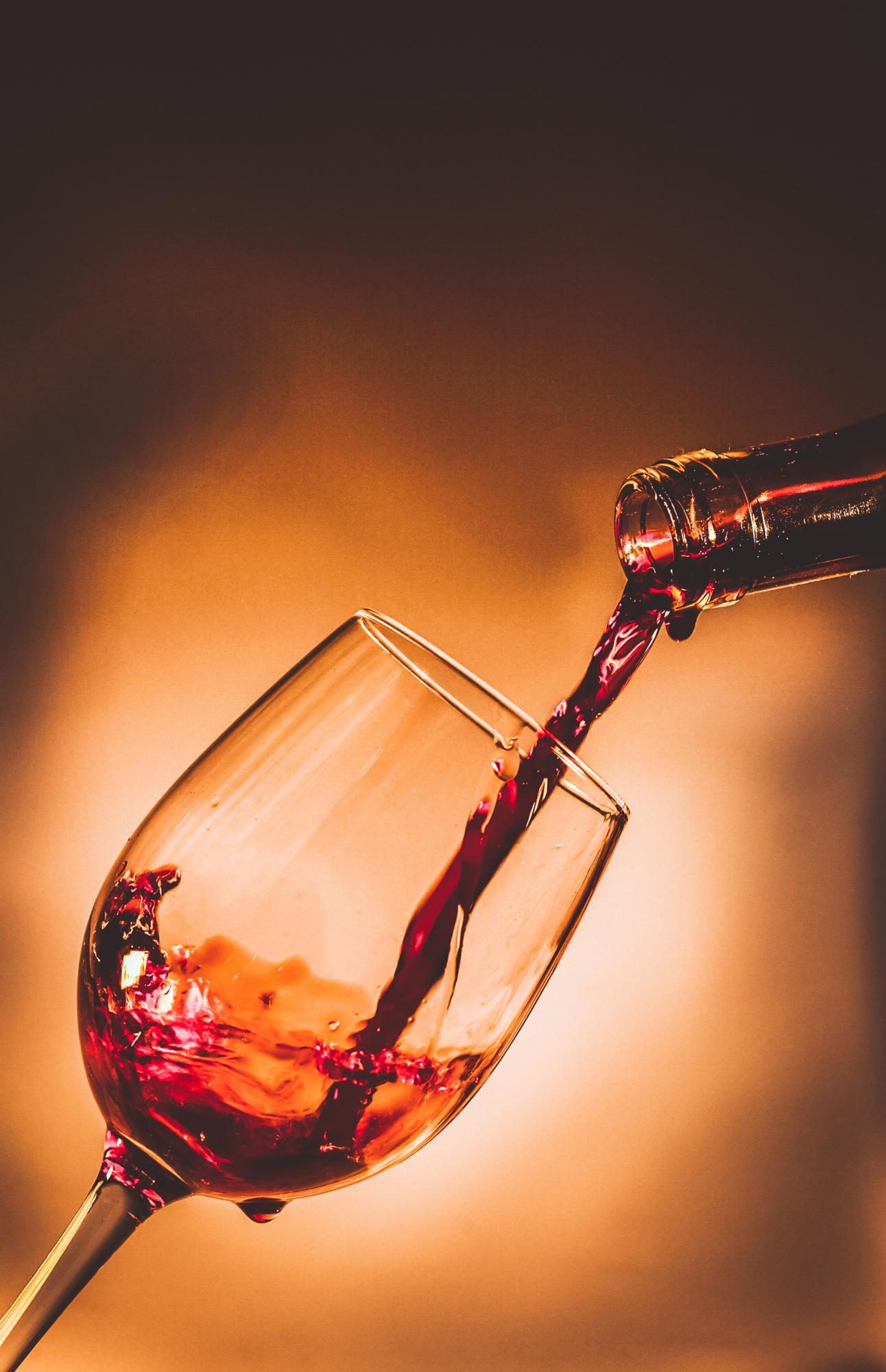 pouring red wine in a glass