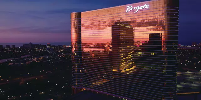 Exterior of Borgata at night shows the city lights reflected in the 41 floors.