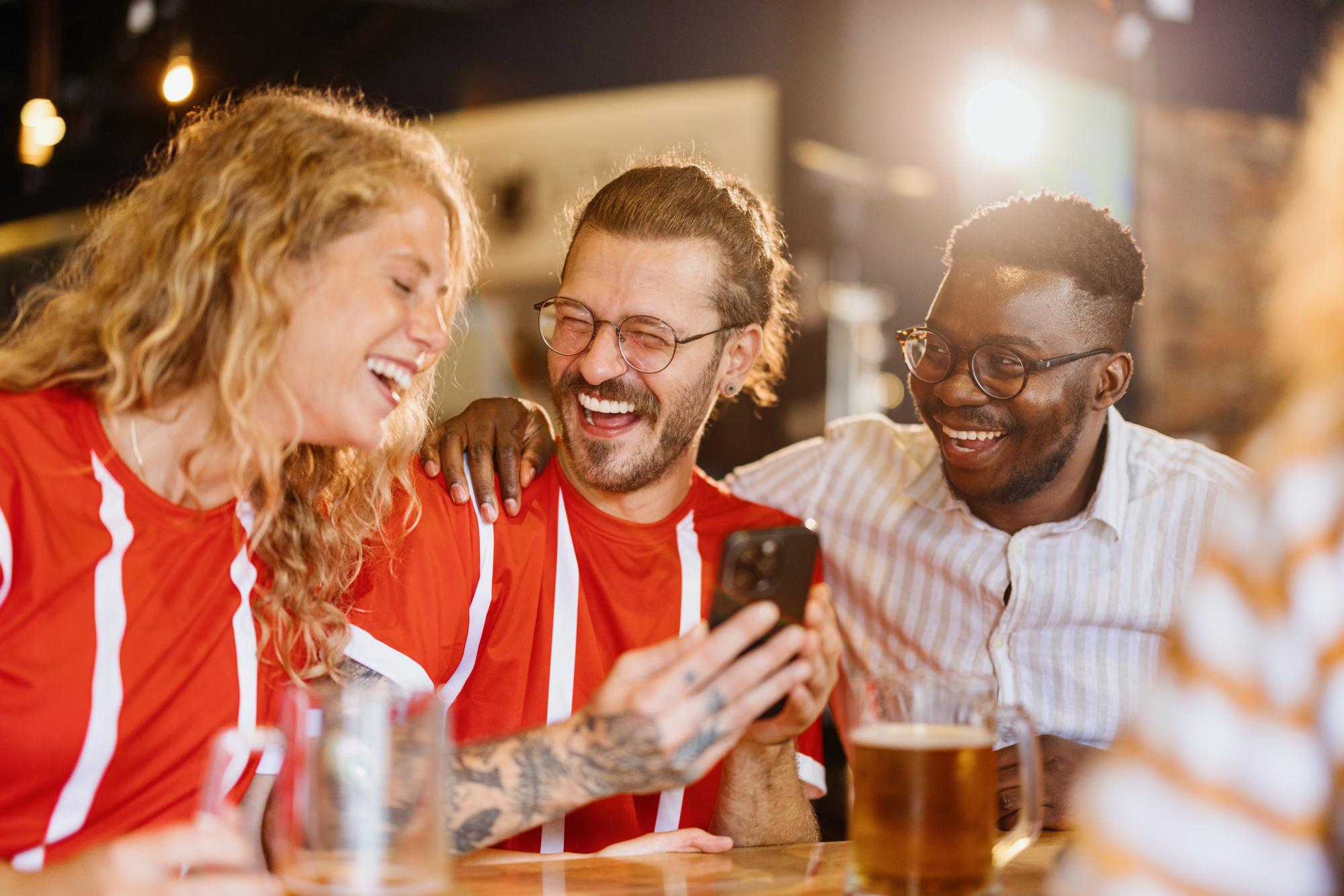 Sports fans cheering for their team in the pub. World cup, friendship, cheering concept