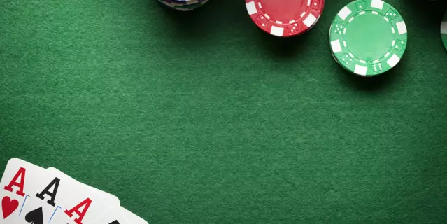 Poker background - chips and cards on green table